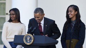 President Barack Obama, with daughters, Sasha, left, and Malia, laughs as he talks about pardoning the National Thanksgiving Turkey Abe, Wednesday, Nov. 25, 2015, during a ceremony in the Rose Garden of the White House in Washington. This is the 68th anniversary of the National Thanksgiving Turkey presentation (AP Photo/Susan Walsh)