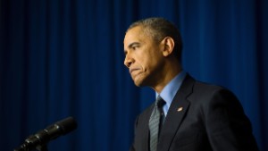 President Barack Obama reacts during a press conference at the Organization for Economic Co-Operation and Development Centre in Paris on December 1, 2015.