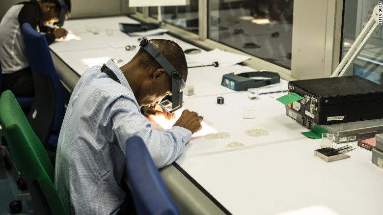 An employee inspects rough diamonds at De Beers&#39; Global Sightholder Sales facility in Gaborone, the largest inspection and valuation operation in the world.