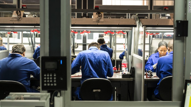 KGK Diamonds employees cut the final facets on round cut diamonds at the company&#39;s Gaborone factory.