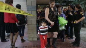 People leave a community center after reuniting with friends and family in the aftermath of the shootings.