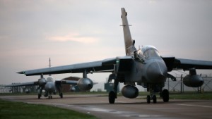 MARHAM, UNITED KINGDOM - NOVEMBER 15: Two Royal Air Force Tornado GR4s taxi along a run way as they arrive at Royal Air Force (RAF) Marham on November 15, 2014 near the village of Marham in the English county of Norfolk, England. The air crew departed their stopover at RAF Akrotiri, Cyprus early this morning after the jets from 31 Squadron left Kandahar airfield in Afghanistan on November 11 after following more than five years in the country. (Photo by Carl Court/Getty Images)