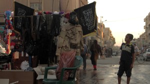 A child looks at stand selling military fatigue in Raqqa on October 1, 2013. At the time Raqqa was held by rebel forces, before ISIS took over.