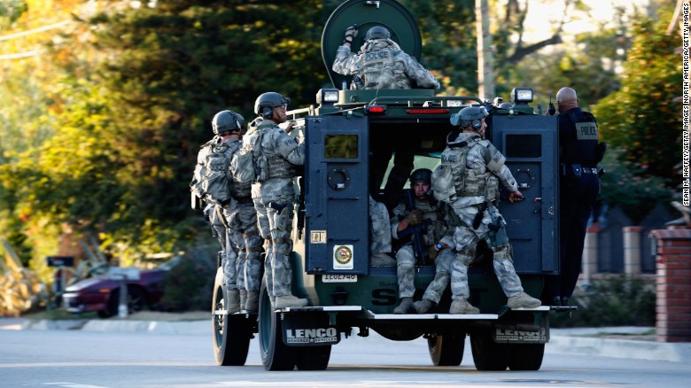 SAN BERNARDINO, CA - DECEMBER 02:  SWAT officers enter an area where suspects were believed to be after the shooting at the Inland Regional Center on December 2, 2015 in San Bernardino, California.  Police continue to search for suspects in the shooting that left at least 14 people dead and another 17 injured.   (Photo by Sean M. Haffey/Getty Images)