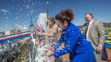 Mouzetta Zumwalt-Weathers christens the Zumwalt during a ceremony at Bath Iron Works on April 12, 2014.