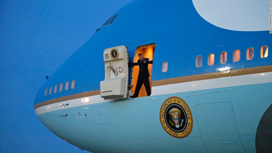 A crew member stands in the door of Air Force One as he waits for stairs to arrive Thursday, January 8, at Joint Base Andrews in Maryland. President Barack Obama was returning from a two-day trip to Michigan and Arizona.