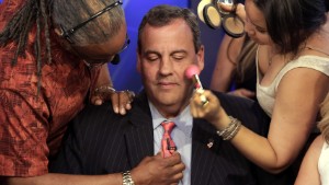FOR USE AS DESIRED, YEAR END PHOTOS - FILE - Republican presidential candidate New Jersey Gov. Chris Christie gets his microphone and make-up prepared for his appearance on "The Five" television program, on the Fox News Channel, in New York, Wednesday, July 22, 2015. (AP Photo/Richard Drew, File)