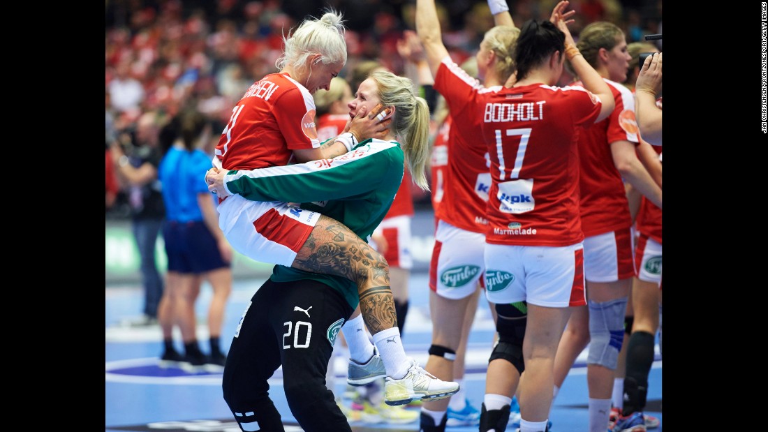 Teammates Kristina Kristiansen, left, and Rikke Poulsen celebrate Sunday, December 13, after Denmark won its round-of-16 match at the Handball World Championship.