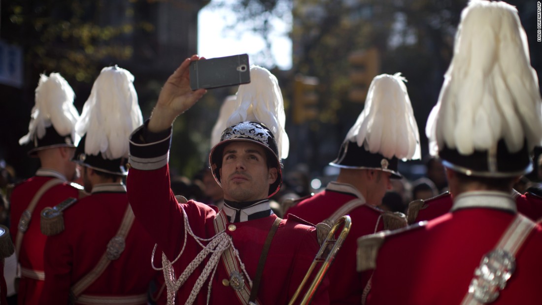 A member of the municipal police band in Barcelona, Spain, takes a selfie before playing at a charity event on Friday, December 11.