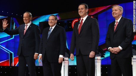 LAS VEGAS, NV - DECEMBER 15:  Republican presidential candidates (L-R) George Pataki, Mike Huckabee, Rick Santorum and Sen. Lindsay Graham (R-SC) are introduced during the CNN presidential debate at The Venetian Las Vegas on December 15, 2015 in Las Vegas, Nevada. Thirteen Republican presidential candidates are participating in the fifth set of Republican presidential debates.  (Photo by Ethan Miller/Getty Images)