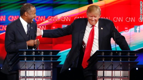 Ben Carson, left, and Donald Trump laugh during the CNN Republican presidential debate at the Venetian Hotel & Casino on Tuesday, Dec. 15, 2015, in Las Vegas. (AP Photo/John Locher)