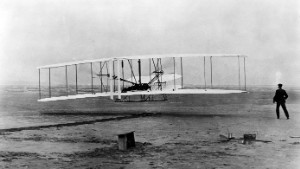 "Original Wright Brothers 1903 Aeroplane ("Kitty Hawk") in first flight, December 17, 1903, at Kitty Hawk, NC. Orville Wright at controls. Wilbur Wright at right (First flight was 12 seconds)"
By Orville Wright and John T. Daniels, December 17, 1903
National Archives and Records Administration, Records of the War Department General and Special Staffs
(165-WW-713-6) [VENDOR # 16] 
