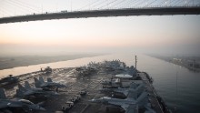 The aircraft carrier USS Harry S. Truman (CVN 75) passes under the Friendship Bridge while transiting the Suez Canal on Dec. 14, 2015. The ship is conducting operations in the Persian Gulf, where Iran claims to have taken footage of the carrier using a drone. Click through the gallery for more images of U.S. Navy aircraft carriers.