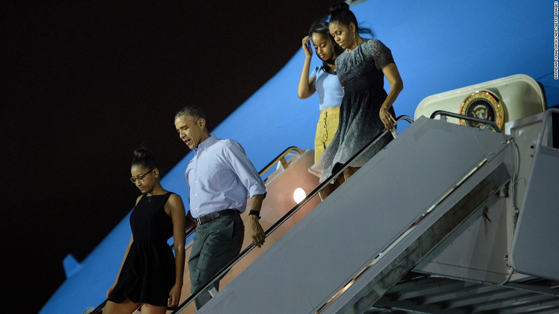 Sasha Obama, from left, President Barack Obama, Malia Obama and first lady Michelle Obama arrive at Hickam Air Force Base in Honolulu on Saturday, December 19.