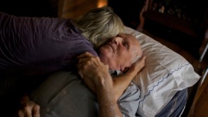 Chris and her father share a nice moment in the living room at his home. Her days are filled with taking care of her father and holding down a job as a nurse in Col, SC. She is always on call in case something takes a turn for the worst. Cayce, SC. 11.1.14