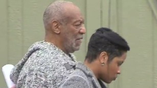 Bill Cosby leaves police station after booking