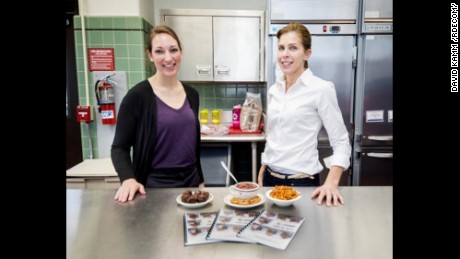 Research dietitians Adrienne Hatch, left, and Holly McClung, from U.S. Army Research Institute of Environmental Medicine, or USARIEM, wrote and illustrated "MRE Recipes" to entice volunteers to stick with USARIEM's meals, ready-to-eat gut health study, which has volunteers consume only the MRE for 21 straight days.