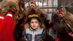 Children wearing bear furs perform during a festival of New Year ritual dances attended by hundreds in Comanesti, northern Romania, Wednesday, Dec. 30 2015. In pre-Christian rural traditions, dancers wearing colored costumes or animal furs, toured from house to house in villages singing and dancing to ward off evil, in the present the tradition has moved to Romania's cities too, where dancers travel to perform the ritual for money. (AP Photo/Vadim Ghirda)