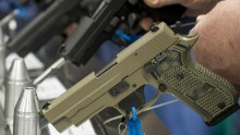 Semi-automatic handguns are displayed at the 143rd NRA Annual Meetings and Exhibits at the Indiana Convention Center in Indianapolis on April 25, 2014.