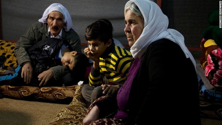 Nouri, 11, rests with his grandparents after escaping from captivity while his 5-year-old brother Saman sleeps.