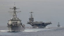 The Arleigh Burke-class destroyer USS William P. Lawrence (DDG 110) leads the Nimitz-class aircraft carrier USS John C. Stennis (CVN 74) during exercises in the Pacific Ocean in August 2015. On Jan. 15, 2016, the Stennis was to leave its homeport of Bremerton, Washington, as the centerpiece of the Navy's Great Green Fleet. The strike group headed by the Stennis "will use energy efficiency measures, to include technologies and operational procedures, and alternative fuel in the course of its normal operations," the U.S. Pacific Fleet said in a statement. According to <a href="http://www.biofuelsdigest.com/bdigest/2016/01/07/navy-to-launch-great-green-fleet-with-77-million-gallon-buy-of-cost-competitive-non-food-advanced-biofuels/" target="_blank">a report from Biofuels Digest</a>, the Navy has acquired 78 million gallons of biofuel blends for use by the Great Green Fleet. Click through the gallery to see more U.S. aircraft carriers.