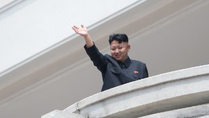 North Korean leader Kim Jong-Un waves to the crowd during a military parade at Kim Il-Sung square marking the 60th anniversary of the Korean war armistice in Pyongyang on July 27, 2013. North Korea mounted its largest ever military parade on July 27 to mark the 60th anniversary of the armistice that ended fighting in the Korean War, displaying its long-range missiles at a ceremony presided over by leader Kim Jong-Un.  AFP PHOTO / Ed Jones        (Photo credit should read Ed Jones/AFP/Getty Images)