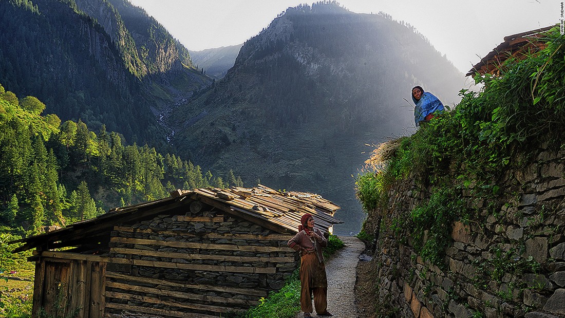 Bara Bangal&#39;s age shows everywhere, from the huts, to the trails through the village, and the walls that keep the mountainside from caving in. Here, two women chat while keeping a lookout for movement on the mountains that could be their husbands leading their flock back to the village.