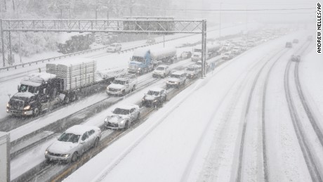 Snow slows down traffic on Interstate 40, Friday morning, Jan. 22, 2016, in Nashville, Tenn. A blizzard menacing the Eastern United States started dumping snow in Virginia, Tennessee and other parts of the South on Friday as millions of people in the storm's path prepared for icy roads, possible power outages and other treacherous conditions. (Andrew Nelles/The Tennessean via AP)