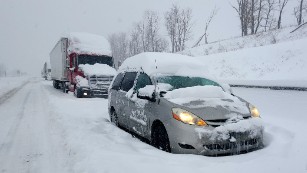 A line of cars and trucks are stuck along the Pennsylvania Turnpike, 20 miles east of Somerset, Pennsylvania.  