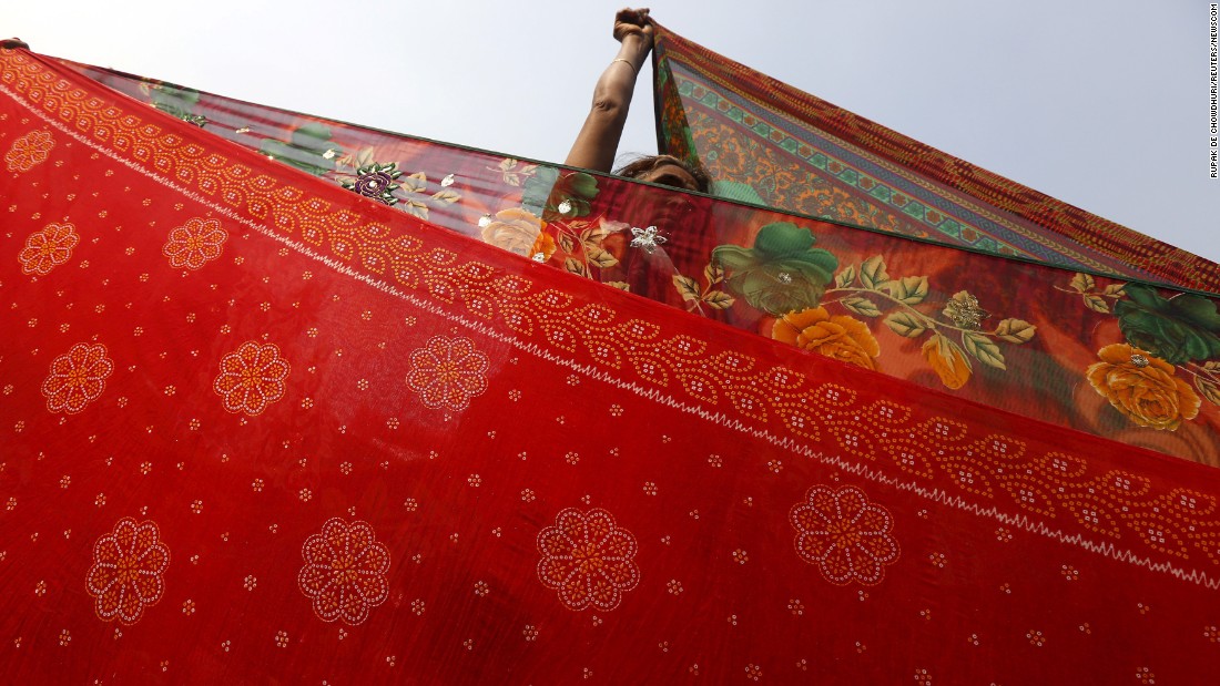 A Hindu pilgrim hangs out saris to dry after taking part in the annual holy dip at Sagar Island on January 14. The event is part of the Makar Sankranti festival, which is celebrated through India, Nepal and Bangladesh. &lt;br /&gt;