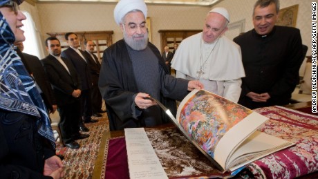 Pope Francis (C) and Iranian President Hassan Rouhani (L) exchange gifts during their private audience on January 26, 2016, at the Vatican.  President Hassan Rouhani described Iran as the safest and most stable country in the Middle East as he urged international investors to help modernise the country&#39;s sanctions-hit economy. On the second day of a landmark visit to Europe, the Iranian leader also pitched the Islamic Republic&#39;s potential for companies seeking a base in a region of 300 million people and vowed the government would never interfere in private business deals.
 / AFP / POOL / ANDREW MEDICHINI        (Photo credit should read ANDREW MEDICHINI/AFP/Getty Images)