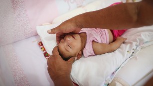 Alice Vitoria Gomes Bezerra, a 3-month-old baby with microcephaly, is placed in her crib by her father, Joao Batista Bezerra, on Wednesday, January 27, in Recife, Brazil. The neurological disorder has been linked to the &amp;lt;a href=&amp;quot;http://www.cnn.com/specials/health/zika&amp;quot; target=&amp;quot;_blank&amp;quot;&amp;gt;Zika virus&amp;lt;/a&amp;gt; and results in newborns with small heads and abnormal brain development. The World Health Organization expects the Zika outbreak to spread to &amp;lt;a href=&amp;quot;http://www.cnn.com/2016/01/25/health/who-zika-virus-americas/index.html&amp;quot; target=&amp;quot;_blank&amp;quot;&amp;gt;almost every country in the Americas.&amp;lt;/a&amp;gt;