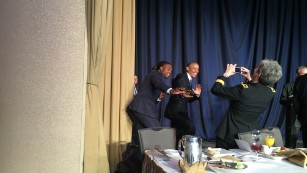 Obama striking the Heisman pose with the most recent Heisman winner Derrick Henry