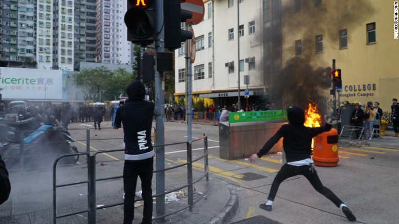 A protester hurls a brick at riot police during clashes in Mong Kok early Tuesday local time.