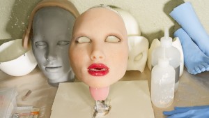 An interchangeable face lies at a work station inside RealDoll in San Marcos, California. The "RealDoll2" has interchangeable faces, which attach to the body via magnets. RealDoll makes life-size "love dolls" manufactured by Abyss Creations, LLC. The dolls, priced from $5,000 and up, have poseable bodies with steel joints and silicone flesh. Photo by Robert Benson.