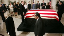 The casket of Chief Justice William H. Rehnquist lies in the Great Hall of the U.S. Supreme Court as Scalia and Sandra Day O'Connor, left, walk past on September 6, 2005, in Washington.