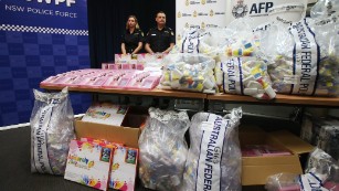Officers stand by a display of confiscated drugs in Sydney.