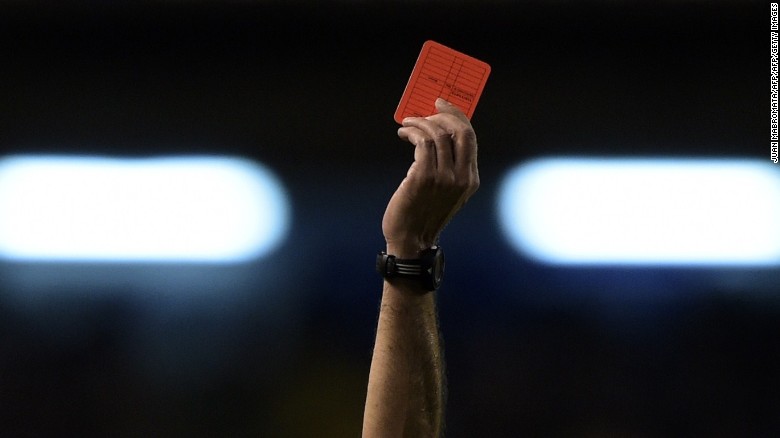 A referee shows a red card during a Copa Sudamericana match in Argentina in 2014.