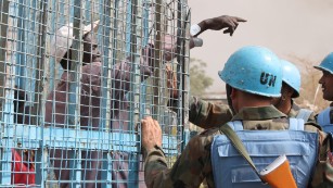A South Sudanese civilian speaks with UN peacekeepers at the United Nations base in the northeastern town of Malakal as clashes continued there Thursday.