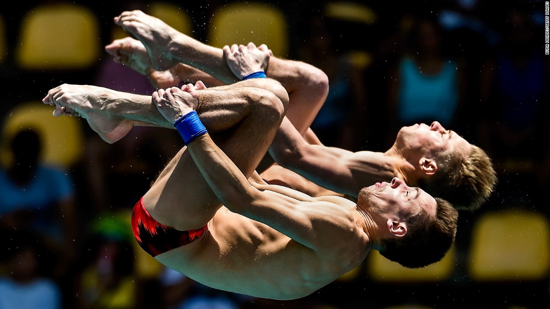 Victor Minibaev, left, and Roman Izmailov perform synchronized dives at the Diving World Cup on Saturday, February 20. The Russians finished fifth in the 10-meter platform.