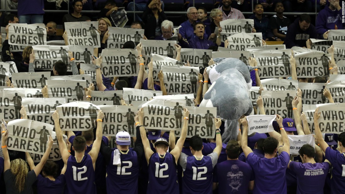 Students from the University of Washington turn their backs to the court as Stanford's starters are introduced before a basketball game in Seattle on Saturday, February 20.