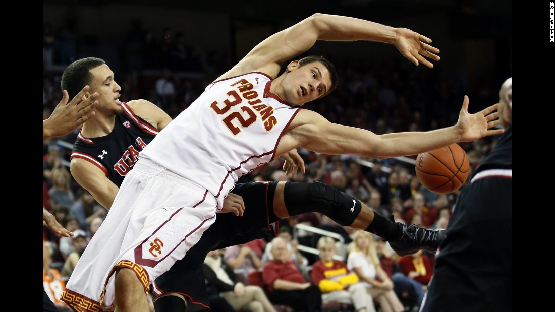USC's Nikola Jovanovic loses the ball after his shot was blocked by Utah's Brekkott Chapman, left, on Sunday, February 21.