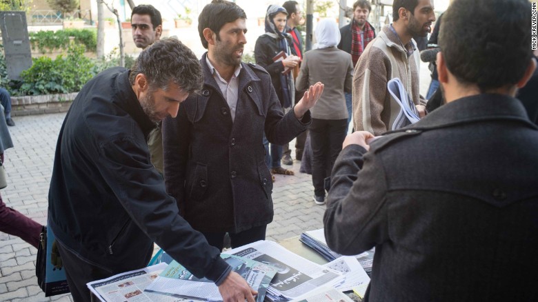 Conservatives -- like these men discussing politics outside an event in Tehran -- also seem energized ahead of the upcoming election. They have expressed concerns about undue influence by the West, specifically the United States and Britain.