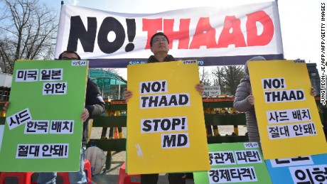 Anti-war activists hold placards during a rally against THAAD in 2016.