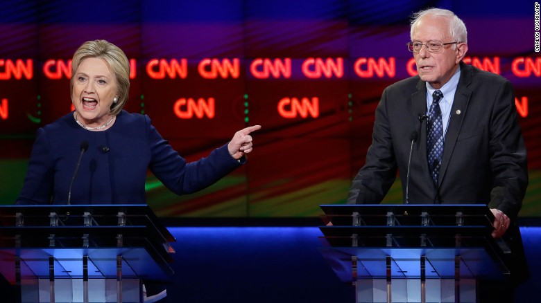 Democratic presidential candidate, Hillary Clinton argues a point as Sen. Bernie Sanders, I-Vt., right, listens during a Democratic presidential primary debate at the University of Michigan-Flint, Sunday, March 6, 2016, in Flint, Mich. (AP Photo/Carlos Osorio)