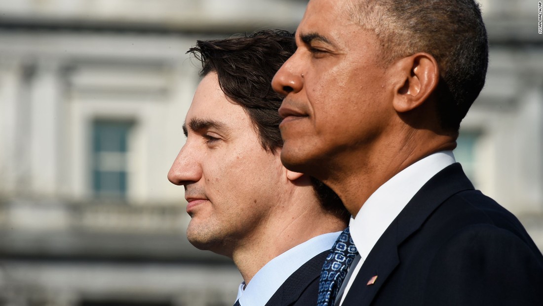 The two leaders listen to the Canadian national anthem during a ceremony on the South Lawn of the White House on March 10.