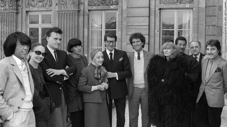 Sonia Rykiel (in black feathers) poses with the French Minister of Culture Jack Lang (7th L) and her fashion contemporaries fashion in Paris in 1984. 