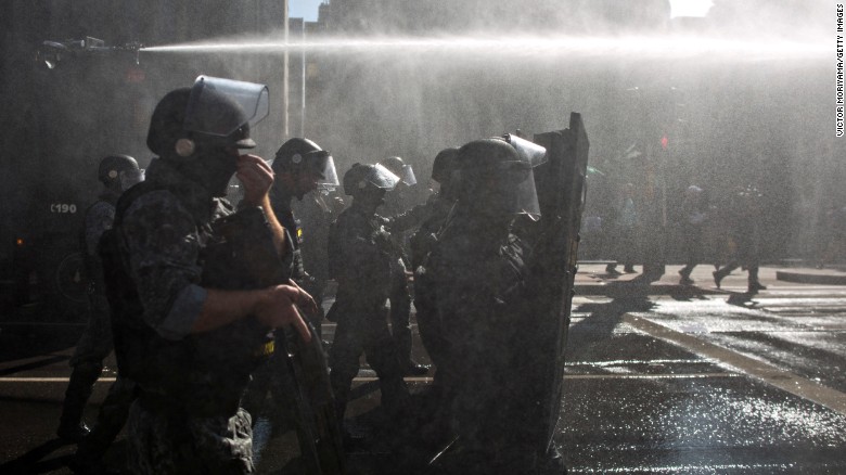 Police use water cannons Friday, March 18, to clear the main avenue of Sao Paulo, Brazil, where people were protesting Brazilian President Dilma Rousseff and her ministerial appointment of former President Luiz Inacio Lula da Silva. Rousseff named Lula da Silva as her chief of staff, and her critics say it is an attempt to shield him from a corruption investigation.