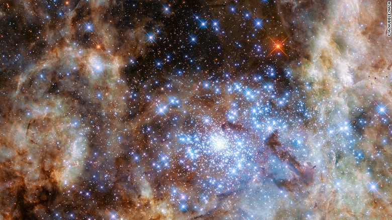 This image shows the central region of the Tarantula Nebula in the Large Magellanic Cloud. The young and dense star cluster R136, which contains hundreds of massive stars, can be seen in  the lower right of the image. It was taken by the Hubble Space Telescope.