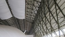 The old hangar is a protected building under English planning laws and was carefully restored to accommodate the Airlander. Those overhead drapes are to catch droppings from birds entering the building.